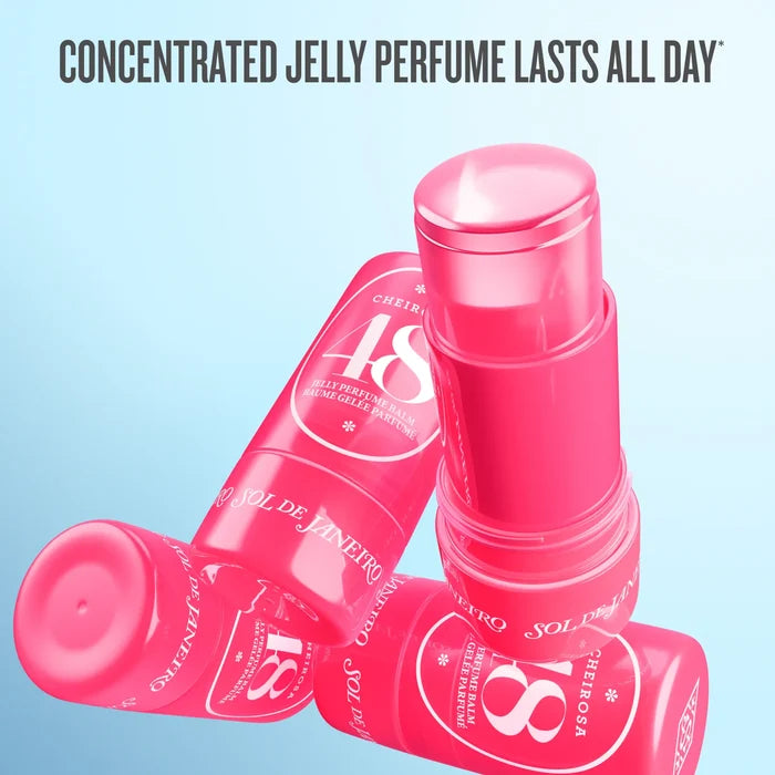 Four pink Sol de Janeiro Cherry 18% jelly perfume stick containers arranged on a light blue gradient background, with the text 'CONCENTRATED JELLY PERFUME LASTS ALL DAY' at the top.