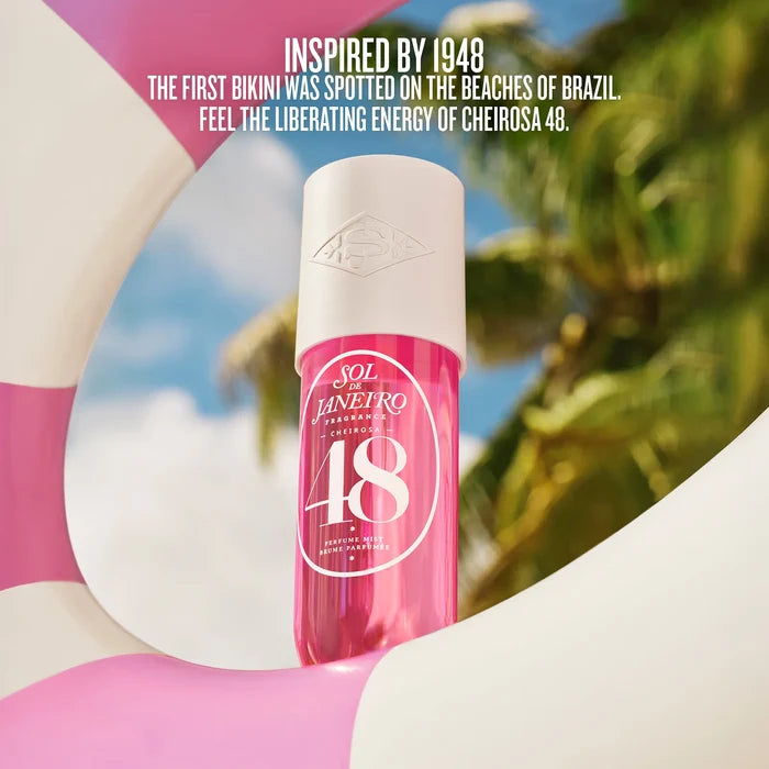 Pink bottle with white cap on a blurred beach background