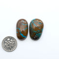 Egyptian Turquoise offers blue tones and a natural matrix on a white background, with a dime for reference. Ideal for handcrafted jewelry, custom designs, and gemstone collections.