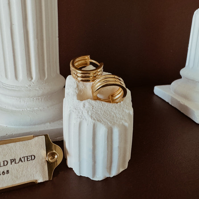 Small gold hoop earrings with ribbed texture and triple hoop design
