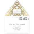 White envelope with golf geometric lines on the back flap. White box holding return address, black deco font mailing address on the front of the envelope.