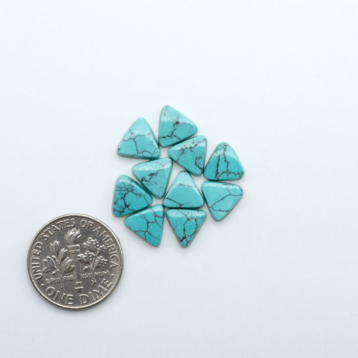 Hubei Cloud Mountain Turquoise cabochons, blue and green color with black matrix, polished stones on a white background with a US dime for scale