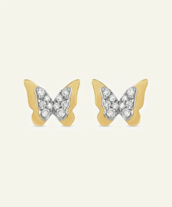Butterfly-shaped earrings with gold and silver design on a white background