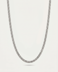 A silver-toned metallic chain necklace with a textured, woven link design, shown draped against a light off-white background.