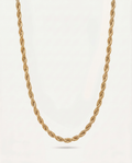 A gold rope chain necklace displayed against a clean, off-white background.