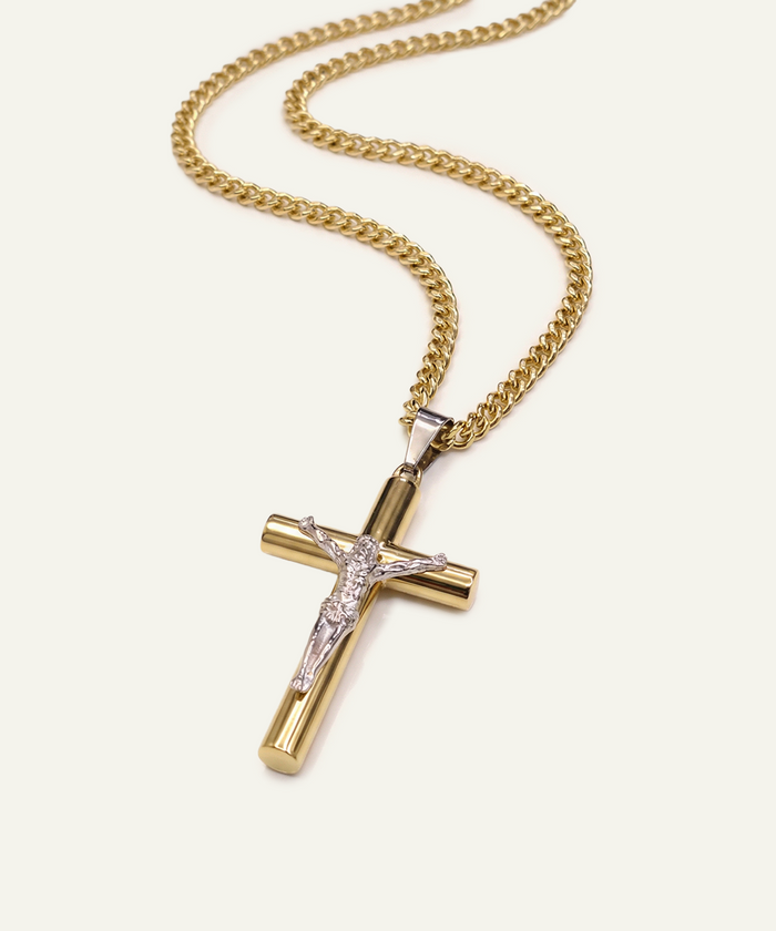 Gold cross pendant necklace on a white background