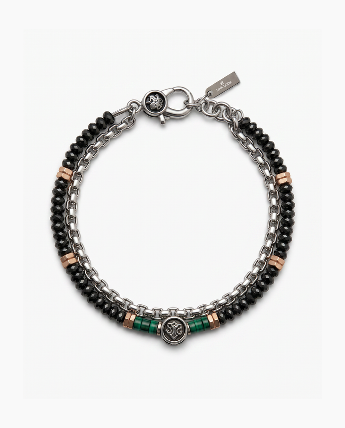 A men's multi-strand bracelet featuring black faceted beads, silver-tone chain links, rose gold spacer beads, and green accent beads, with a round medallion charm and lobster clasp closure.