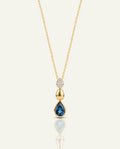 Gold necklace with a diamond pendant on a white background