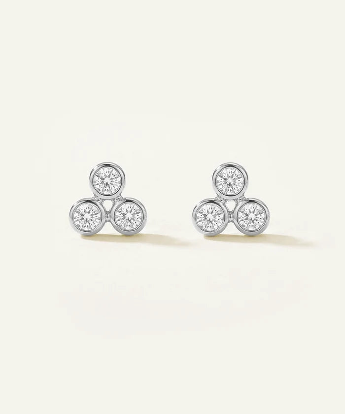 Pair of diamond stud earrings on a light background