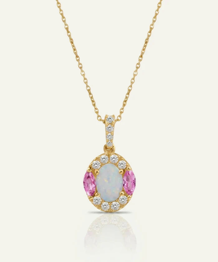 Gold necklace with a pendant featuring pink gemstones and diamonds on a white background