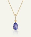 Gold necklace with a purple teardrop pendant on a white background
