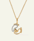 Gold necklace with a heart and footprints pendant on a white background