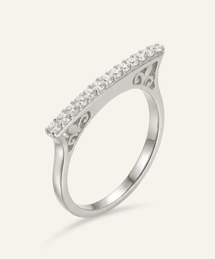 Silver ring with diamond accents on a white background