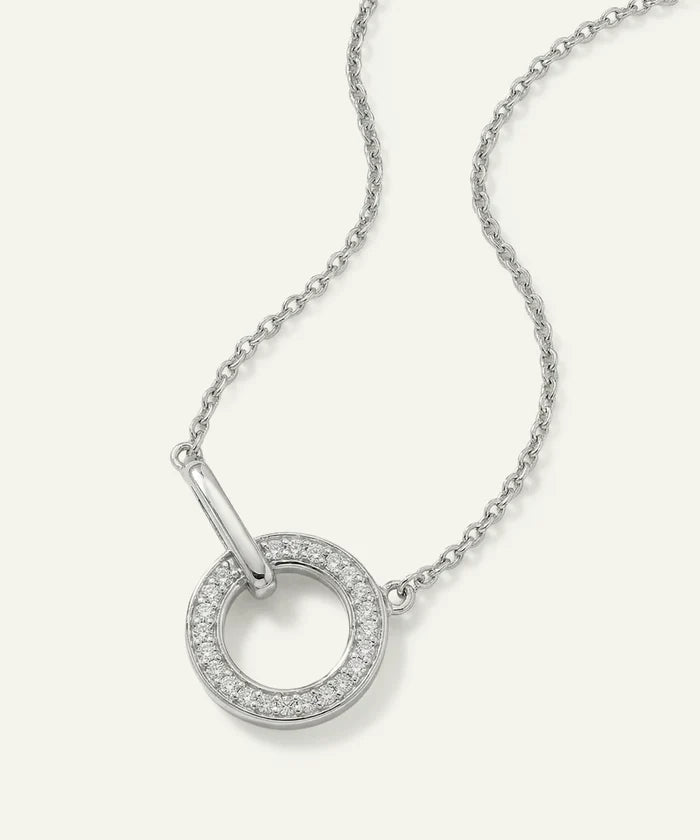 Silver necklace with a circular pendant on a white background