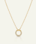 Gold necklace with a circular pendant on a white background