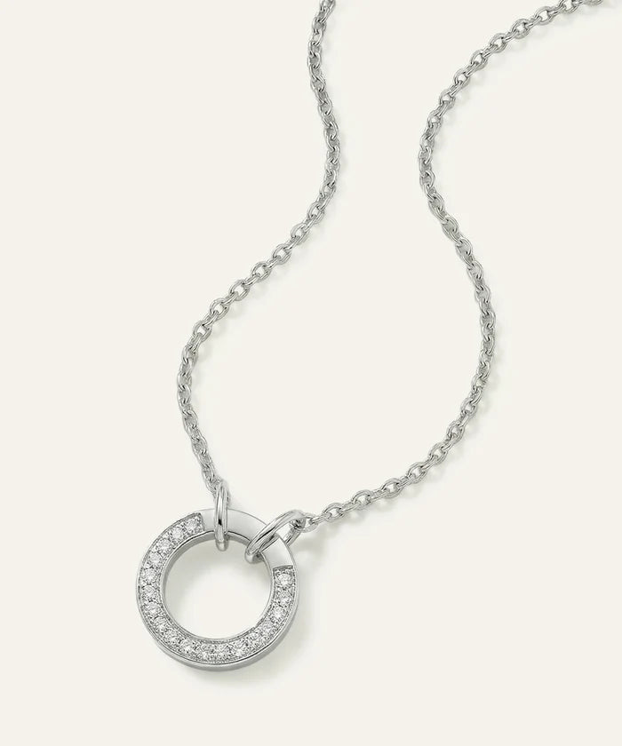 Silver necklace with a circular pendant on a white background