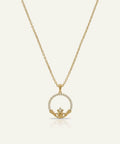 Gold necklace with a claddagh pendant on a white background