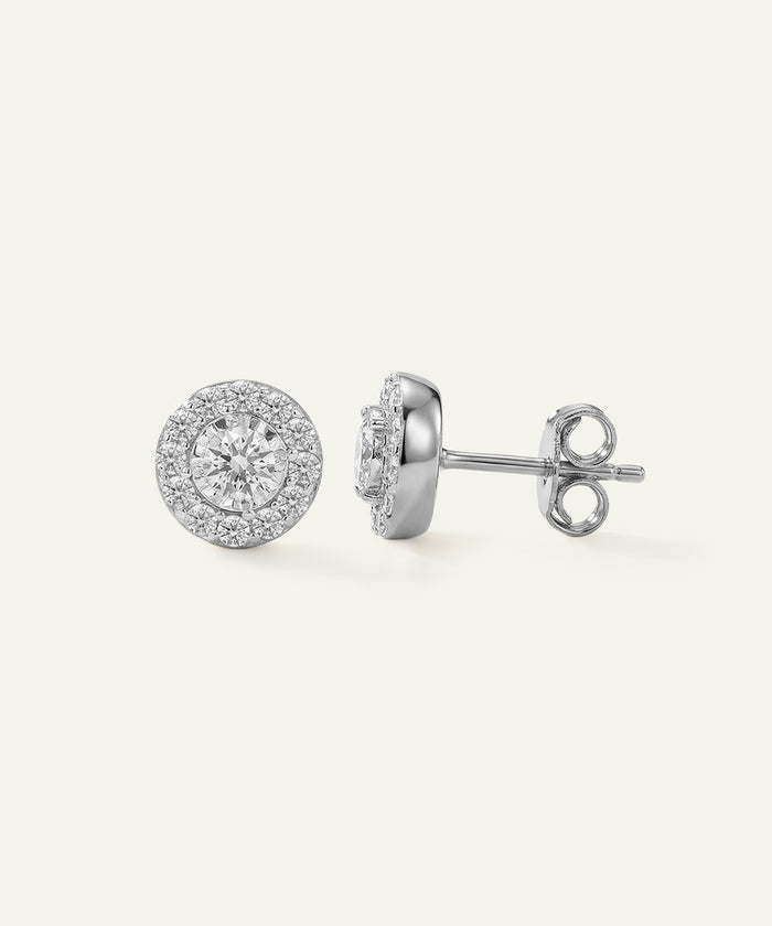Pair of silver stud earrings on a white background
