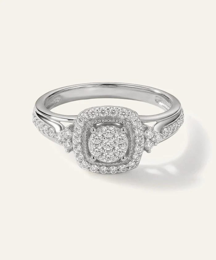 Silver ring with diamond accents on a white background