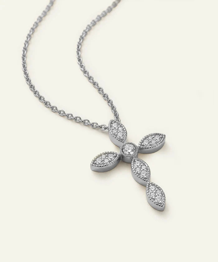 Silver necklace with a cross pendant on a light gray background