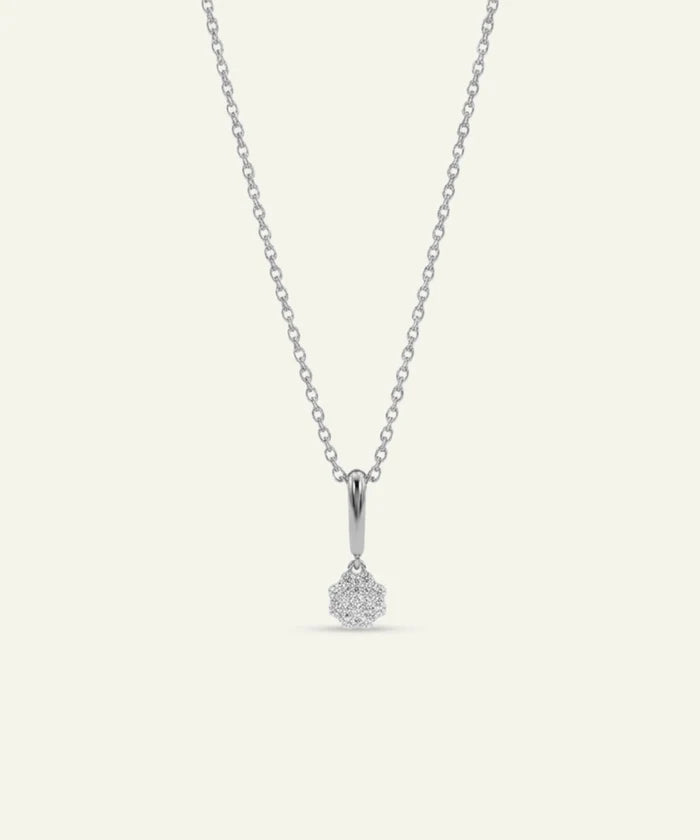 Silver necklace with a teardrop-shaped pendant on a light gray background