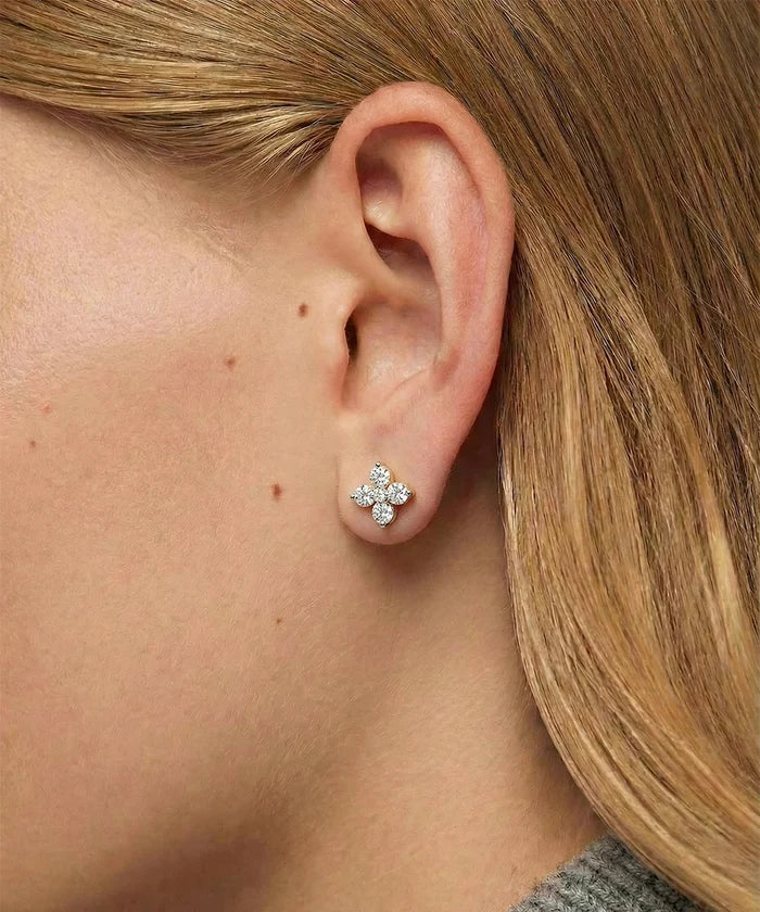 Close-up of a person wearing a diamond earring.