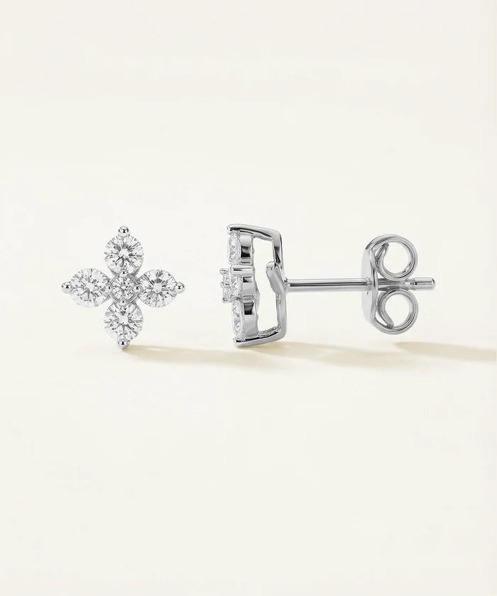 Pair of diamond stud earrings on a light background