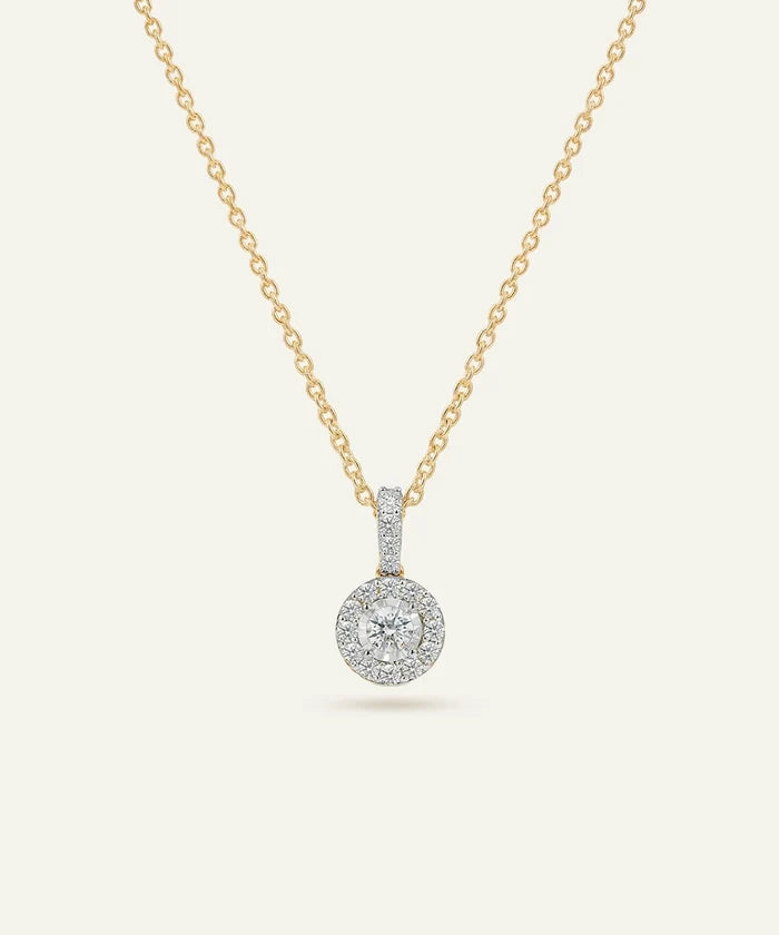 Gold necklace with a diamond pendant on a white background