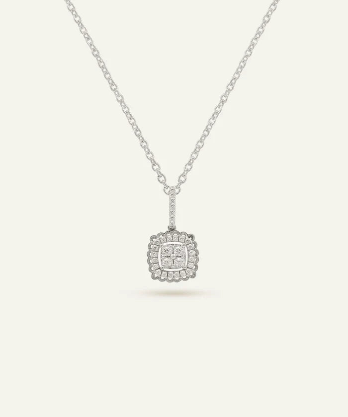 Silver necklace with a square pendant on a light gray background