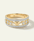 Gold ring with heart design and diamonds on a white background
