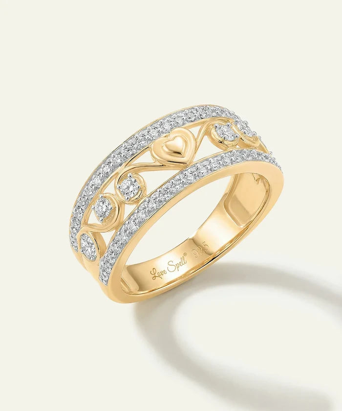 Gold ring with diamond accents on a light background
