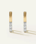 Gold and diamond earrings on a white background