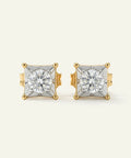 Pair of gold and diamond stud earrings on a light beige background