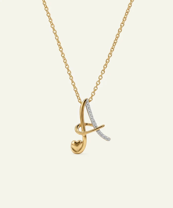 Gold and silver necklace with a heart pendant on a beige background