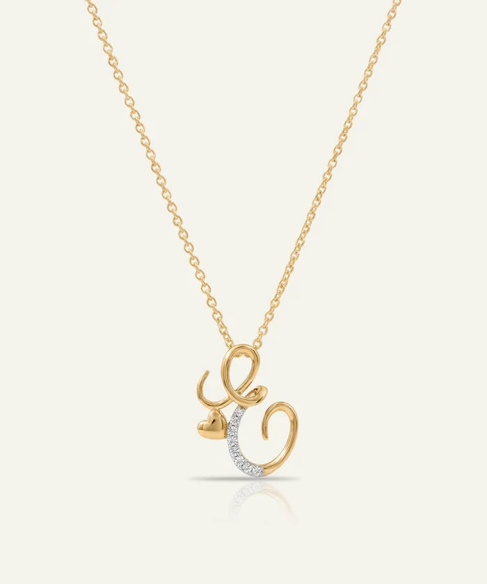 Gold necklace with a unique pendant on a light beige background