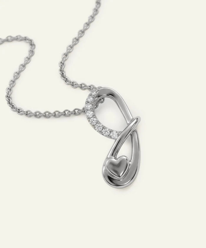 Silver necklace with a heart-shaped pendant on a white background