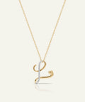 Gold necklace with a letter 'L' pendant on a white background