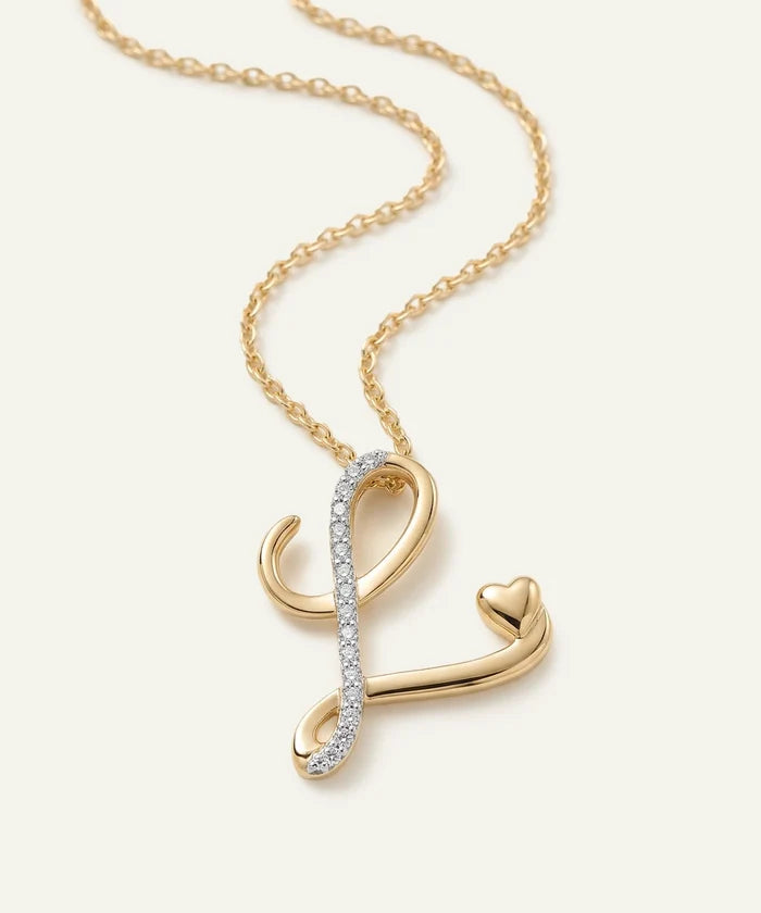 Gold necklace with a unique pendant on a light beige background