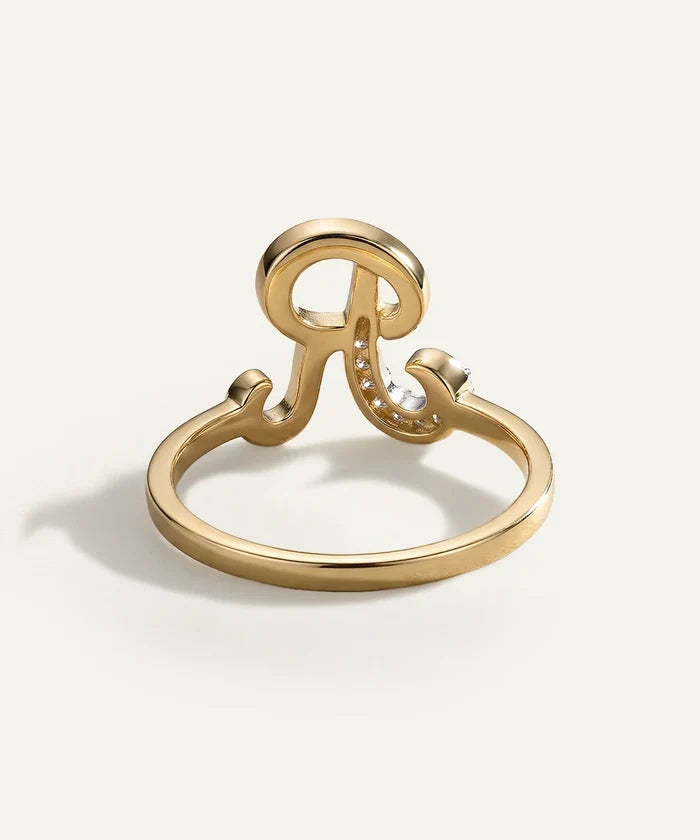 Gold ring with a unique design on a white background