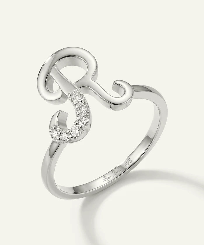 Silver ring with a unique design on a white background