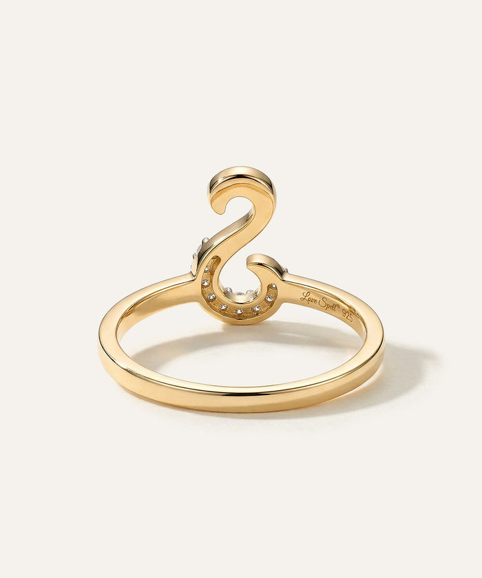 Gold ring with a unique design on a white background