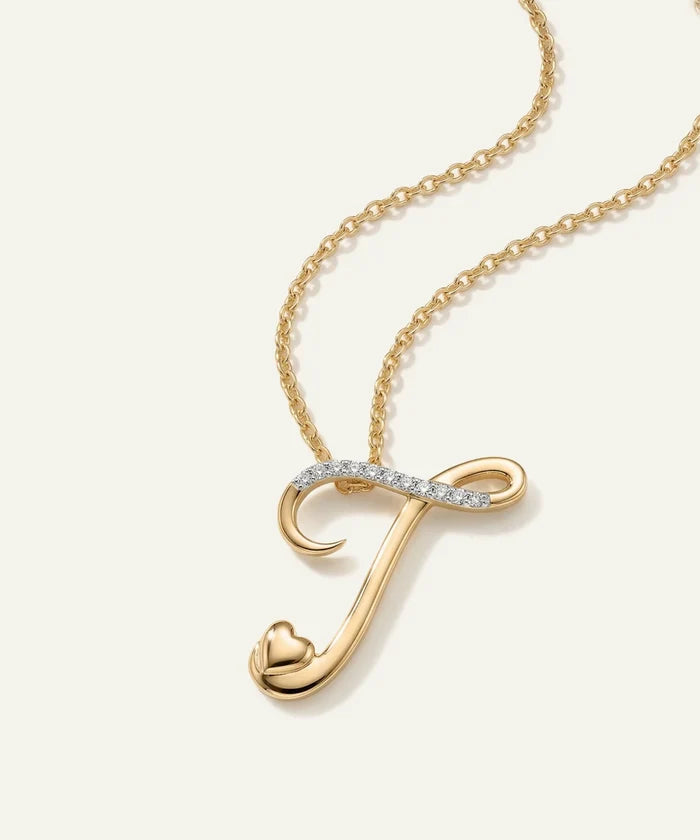 Gold necklace with a 'J' pendant on a white background