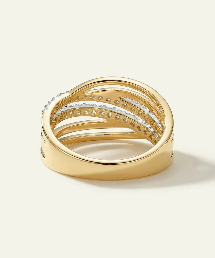 Gold ring with diamond accents on a light background