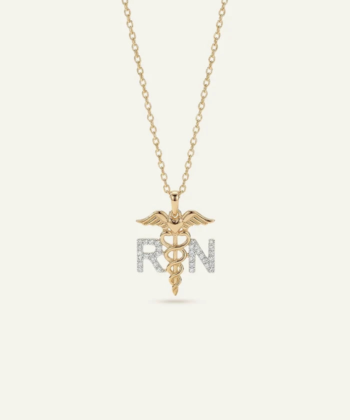 Gold necklace with a medical symbol pendant on a white background