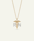Gold necklace with a medical symbol pendant on a white background