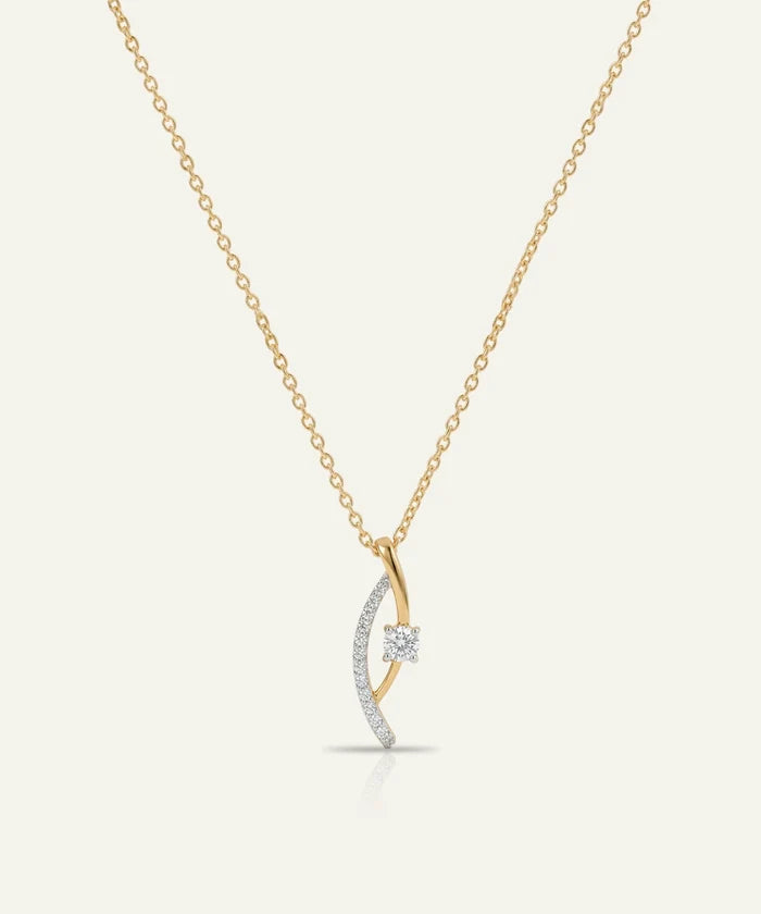 Gold and silver necklace with a crescent moon pendant on a white background
