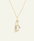Gold necklace with a leaf-shaped pendant on a white background