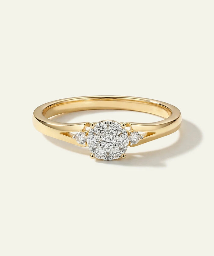 Gold ring with a diamond on a light gray background