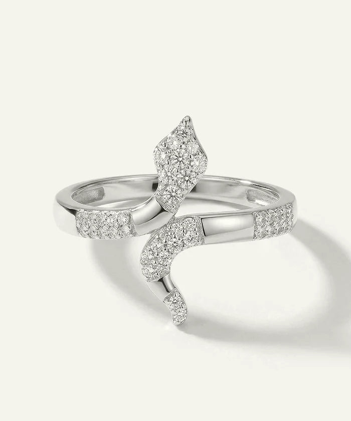 Silver ring with diamond accents on a light gray background