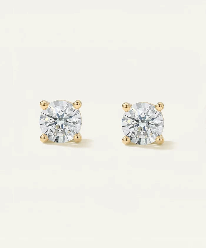 Pair of diamond stud earrings on a light gray background